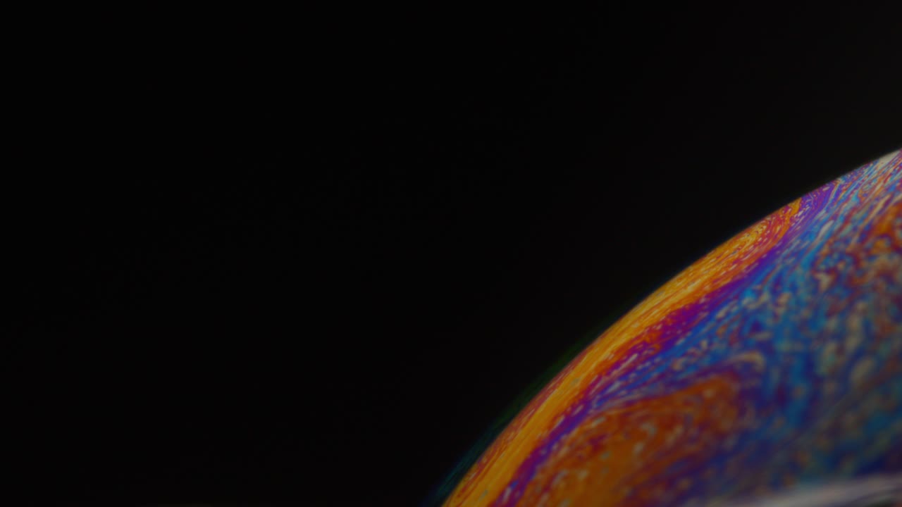 Panning Macro Abstract Shot of Colorful Rainbow Colors on Surface of Bubble