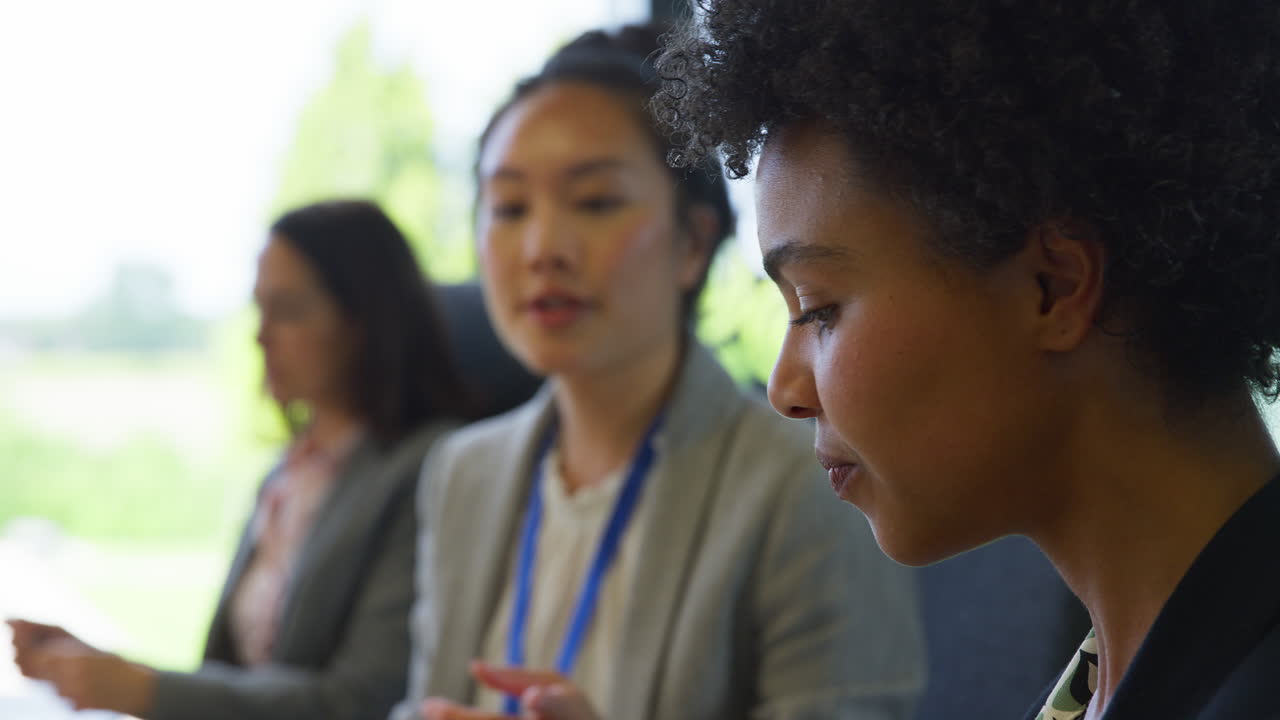 Multi-Cultural Business Team Meeting And Collaborating Around Table In Modern Office Building
