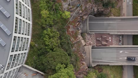 Top-down-view-of-cars-and-traffic-going-into-tunnel-in-Roslagstull-heading-towards-Lidingö,-Stockholm,-Sweden,-Sverige