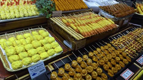 grilled seafood skewers displayed at kyoto nishiki market, vibrant and traditional