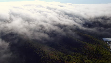 dense fog rolling across the hills, aerial view