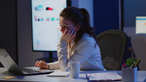 exhausted freelancer sleeping in front of laptop working