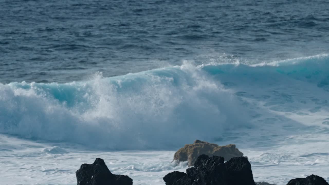 Dramatic ocean waves collide with the volcanic coastline near Timanfaya National Park, located on the island of Lanzarote in the Canary Islands, Spain.
