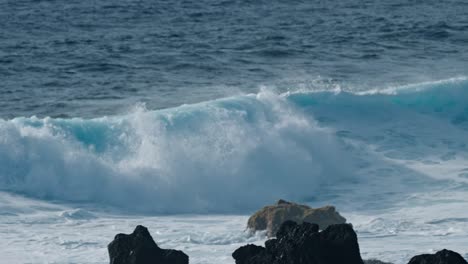 dramatic ocean waves collide with the volcanic coastline near timanfaya national park, located on the island of lanzarote in the canary islands, spain.