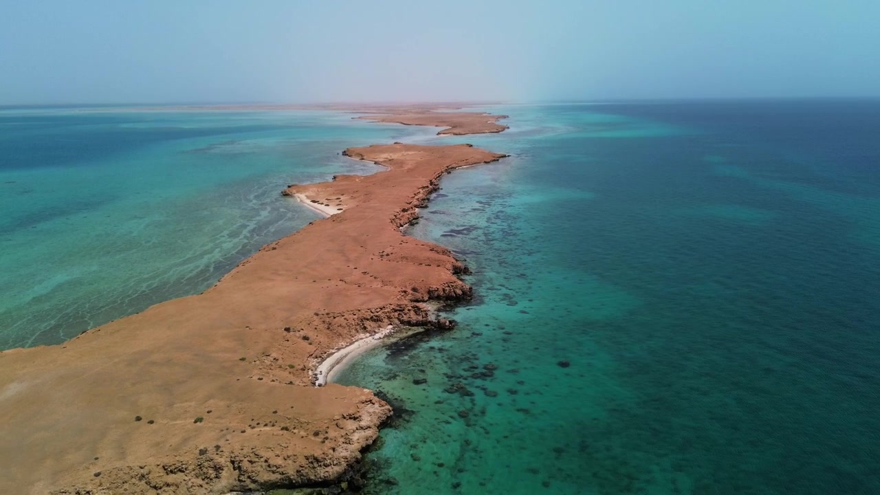 Aerial 4k footage showcasing the pristine narrow peninsula and turquoise waters of Dungunab Bay in the Red Sea, Sudan, Africa.