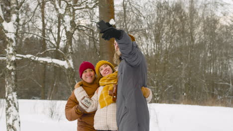 three friends in winter clothes making a selfie 1