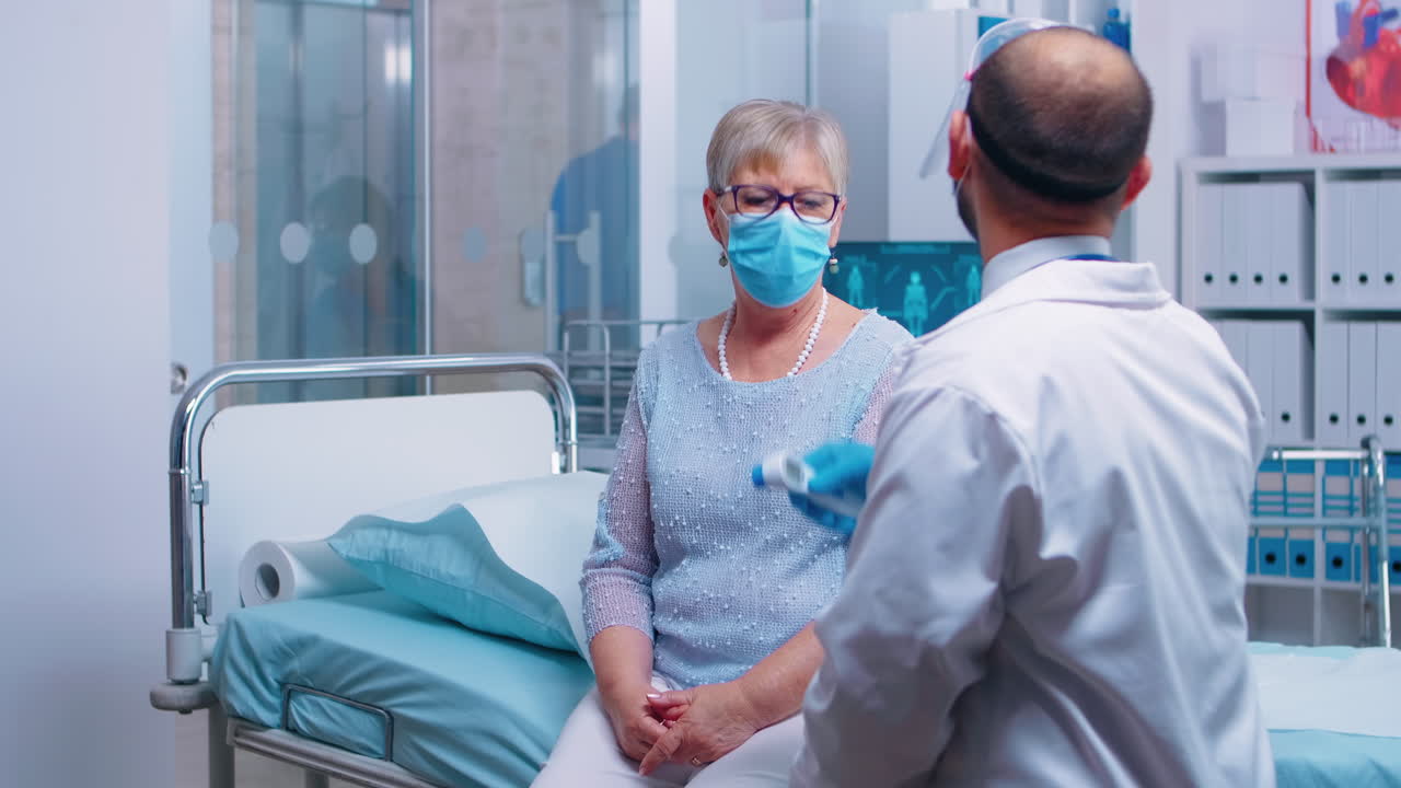 médico usando una pistola de termómetro