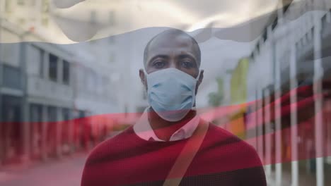 Animation-of-flag-of-russia-waving-over-man-wearing-face-mask-during-covid-19-pandemic