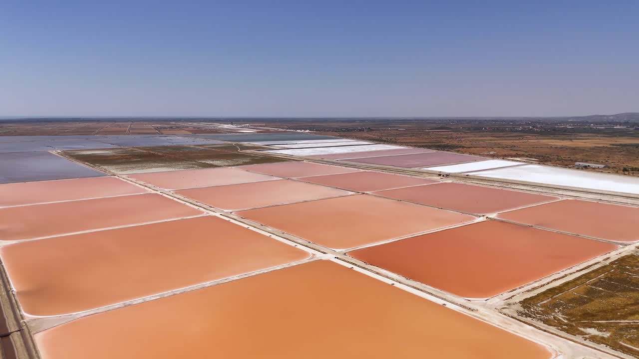Large salt ponds located near the sea filled with seawater used to produce salt