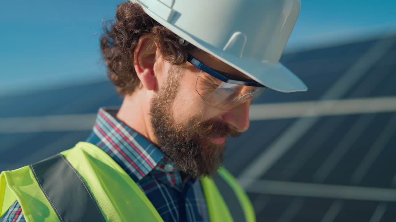 Construction worker inspecting solar panels