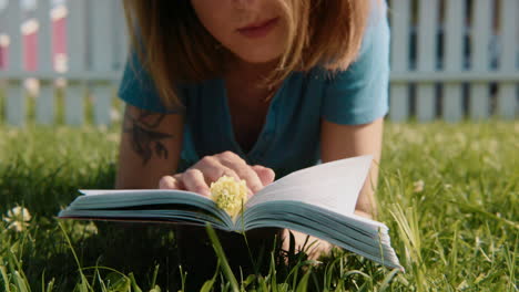 woman reading a book in the grass