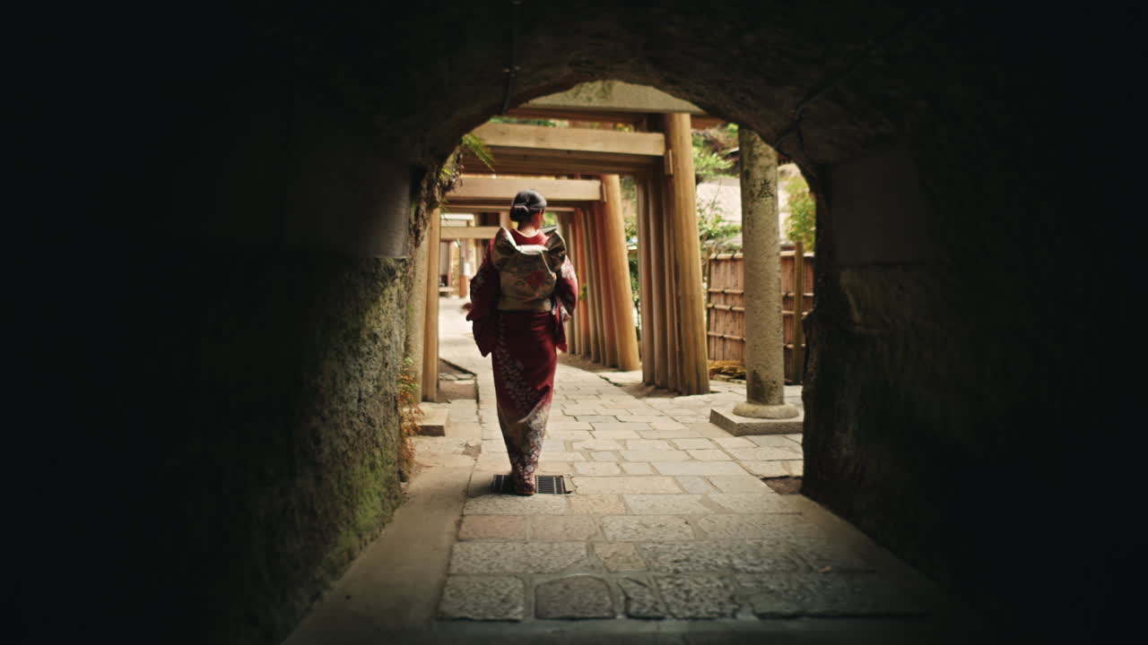 Woman in Kimono Walking Through Torii Gates Tunnel