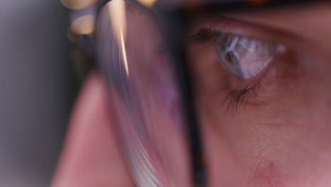 close-up of man's iris while working on laptop