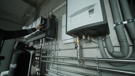 técnico ajustando un sistema de calefacción moderno con tuberías y unidades de control