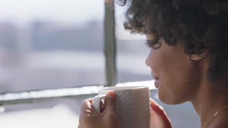 happy woman drinking coffee at home enjoying aroma looking out window planning ahead relaxed african american female with trendy afro hairstyle smiling satisfaction