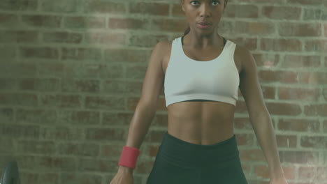 animación de puntos de luz sobre una mujer afroamericana levantando pesas en el gimnasio