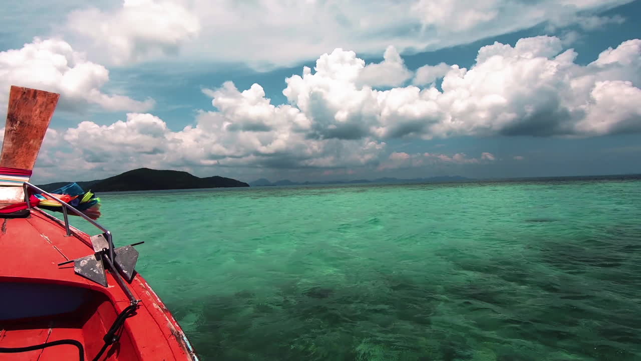 Longtail boat sailing to the island of tropical paradise