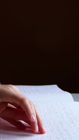 estudiante leyendo un libro en braille en el aula