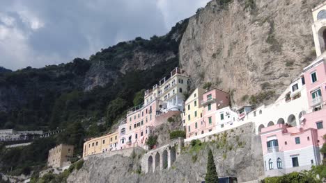 colorful houses at the cliff side of amalfi coast in italy - low angle