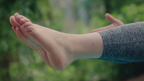 girl practices yoga feet in the air detail