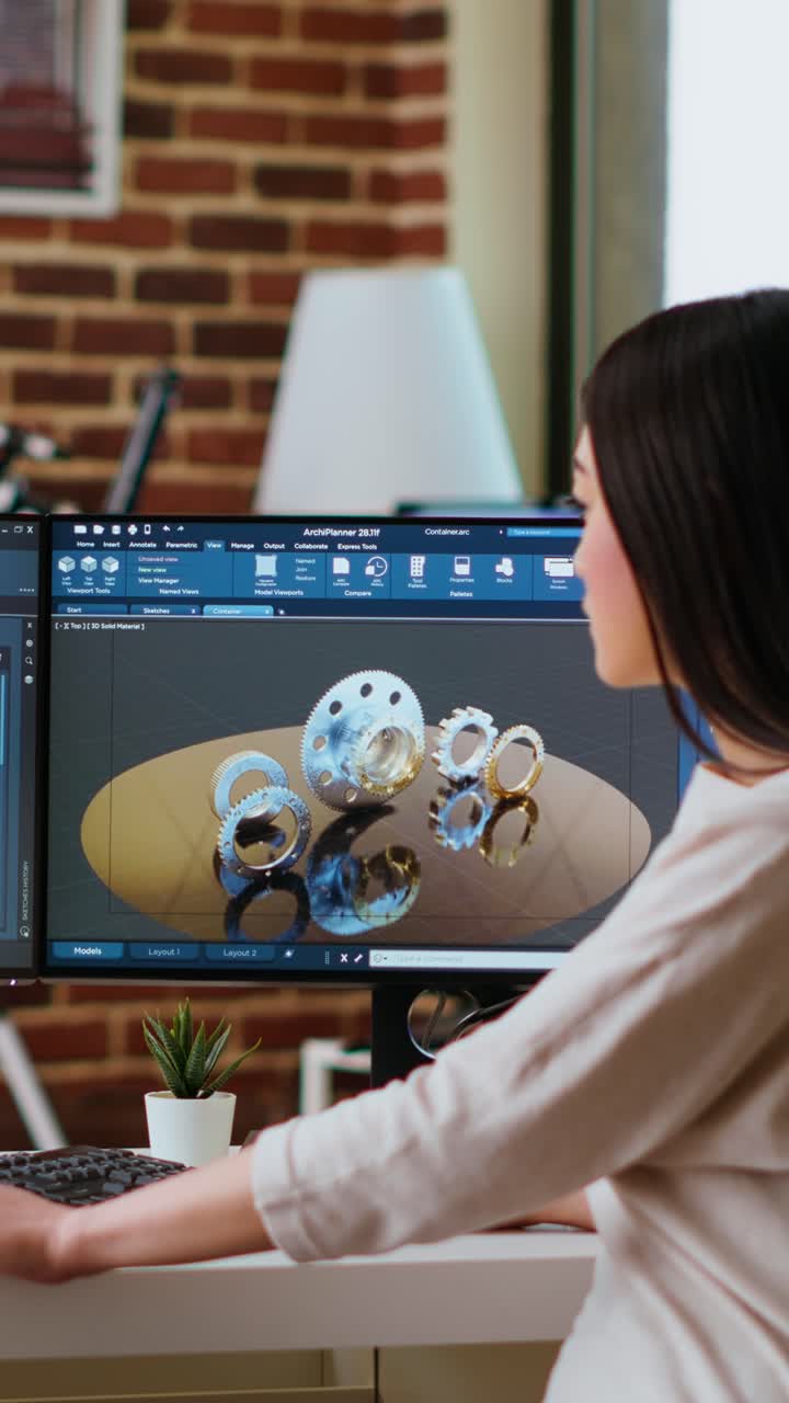 Vertical Video Professional industrial designer working with CAD software on dual monitors