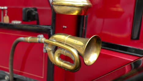 close up shot of an old lantern and a brass horn on an oldtimer bus coach