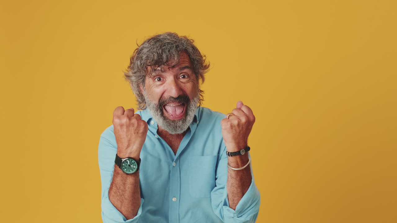 Mature Man Expresses Surprise Then Celebrates with Joy
