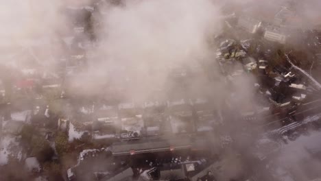 aerial view of dense cityscape through clouds