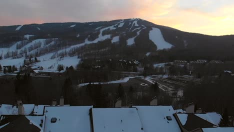 Drone-view-of-ski-resort-during-snowy-winter-at-dusk