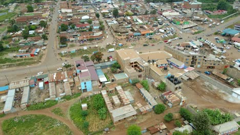 aerial view of cars on streets in a town in east africa - descending, drone shot