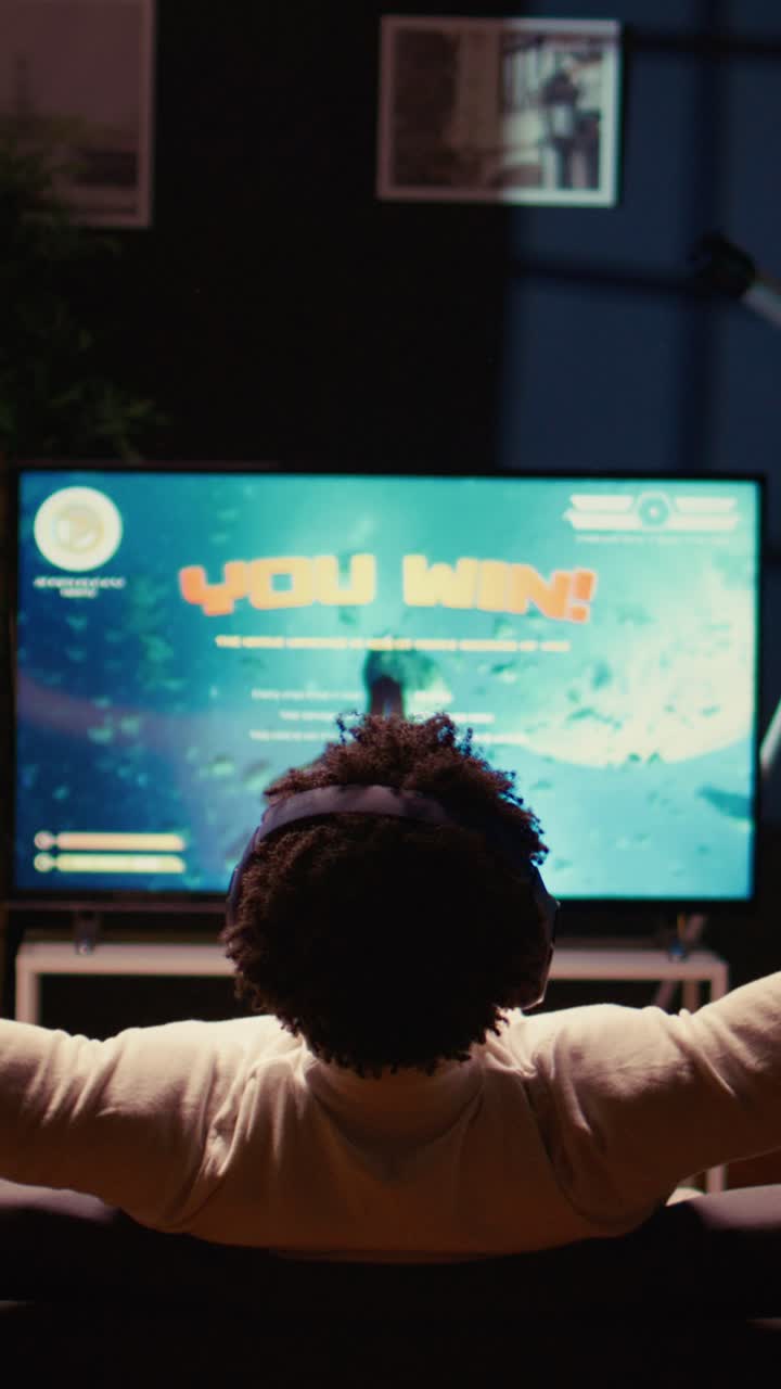 Vertical video Player victorious in videogame displayed on ultrawide TV after defeating boss and saving galaxy