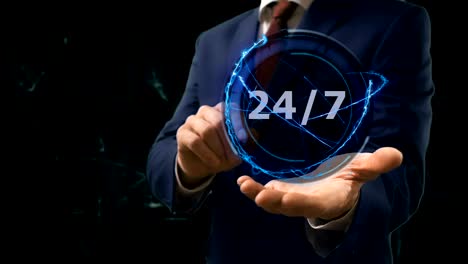 businessman shows concept hologram 24 7 on his hand