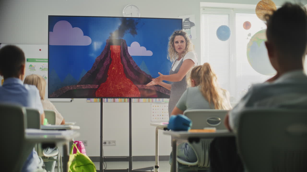 Geology Class Female Teacher Teaching Primary School Children Using Digital Screen