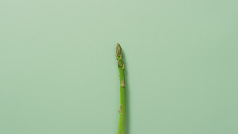 video of fresh asparagus with copy space over green background