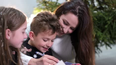 Mom Communicates with Children on Christmas Eve a Happy Family Mom Communicates with Children on Christmas Eve a Happy Family is Resting at Home