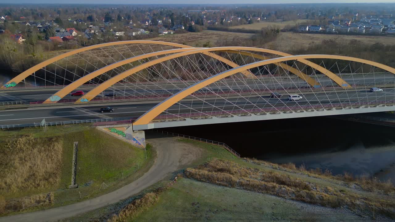 time lapse of Modern german highway bridge carrying vehicle traffic over a river and connecting landscapes. Unbelievable aerial view speed ramp hyper motion time lapse ascending raise up drone