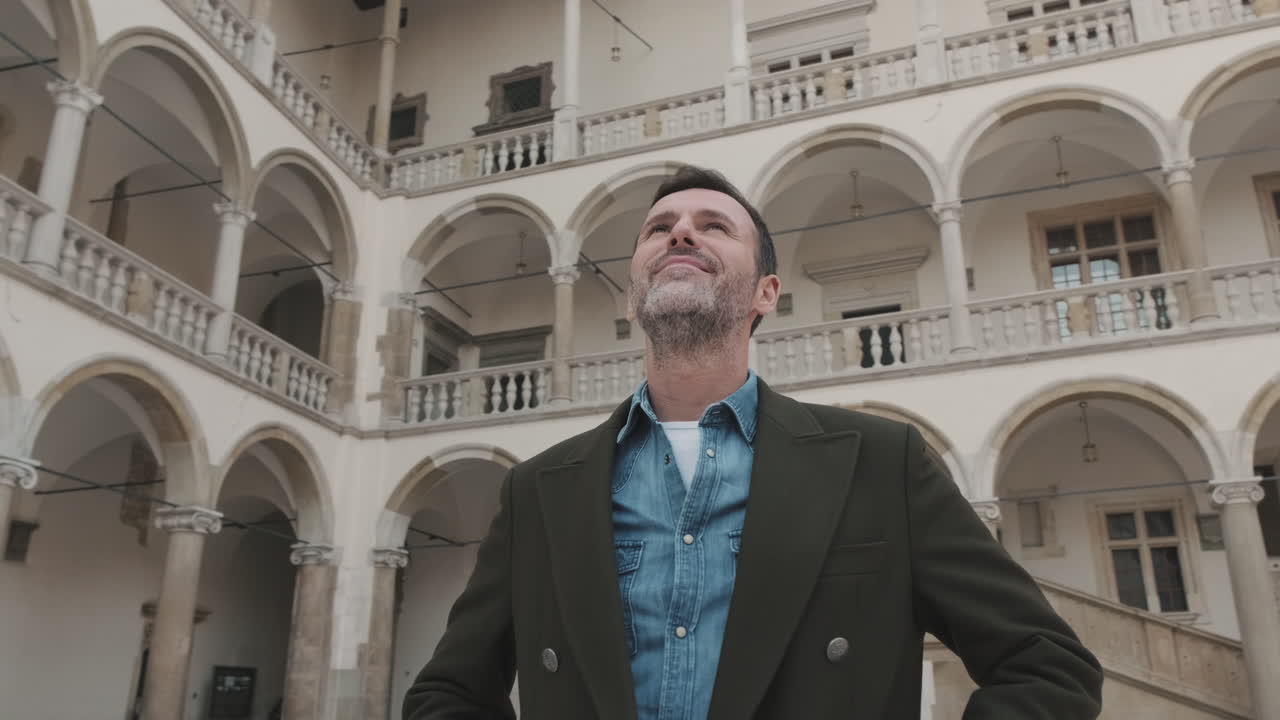 Man standing in front of an architectural building