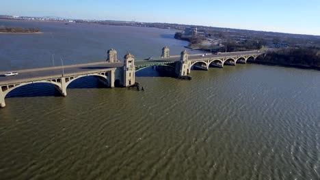 area wide shot over rough water on a windy day, traffic is visible on the historic bridge