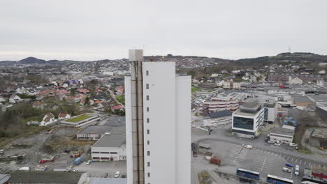 drone orbit shot around tower of fish feed factory - stavanger, rogaland, norway