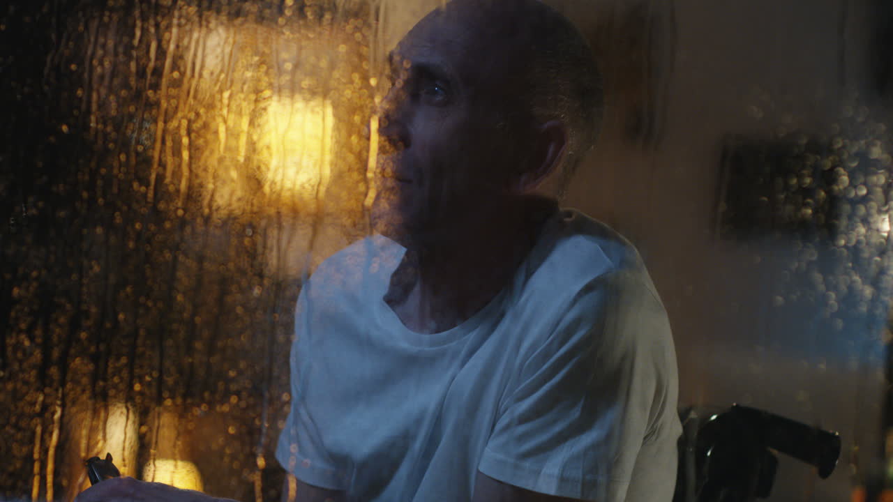 Elderly Man Contemplating at Night