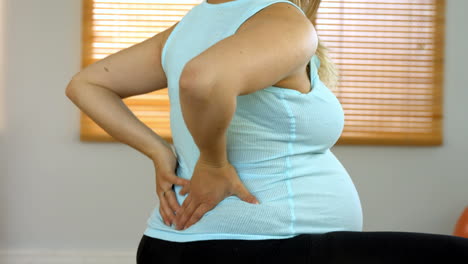 pregnant woman rubbing her lower back