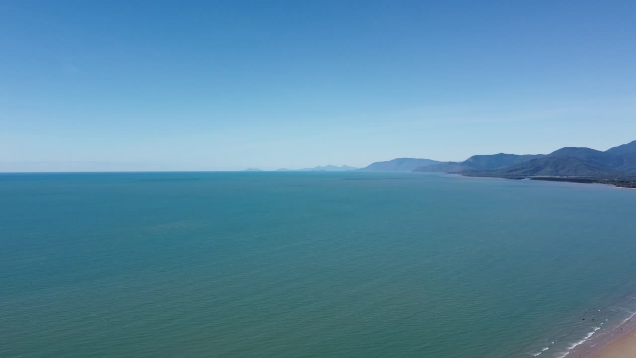 Sweeping aerial view of the beautiful Four Mile Beach and the Pacific Ocean in North Queensland, Australia