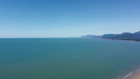 sweeping aerial view of the beautiful four mile beach and the pacific ocean in north queensland, australia