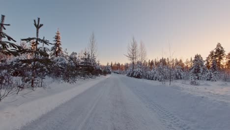 scenic pov drive in snow covered winter forest finland sun rays landscape