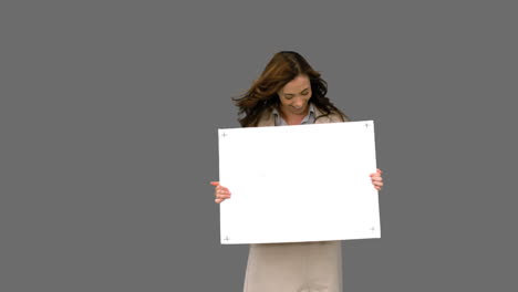 businesswoman presenting blank board on grey screen