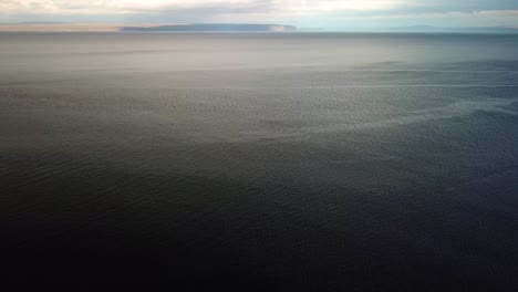 aerial landscape view of empty blue ocean water, with a calm rippled surface