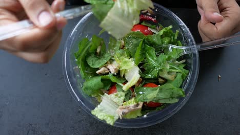 person eating a chicken salad