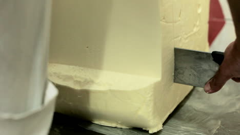 Butter-block-cutting.-Big-stick-of-butter-cutting.-Slicing-butter-piece