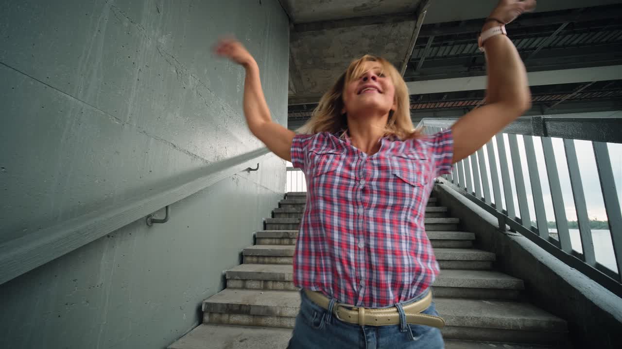Woman Dancing on Stairs in Urban Setting