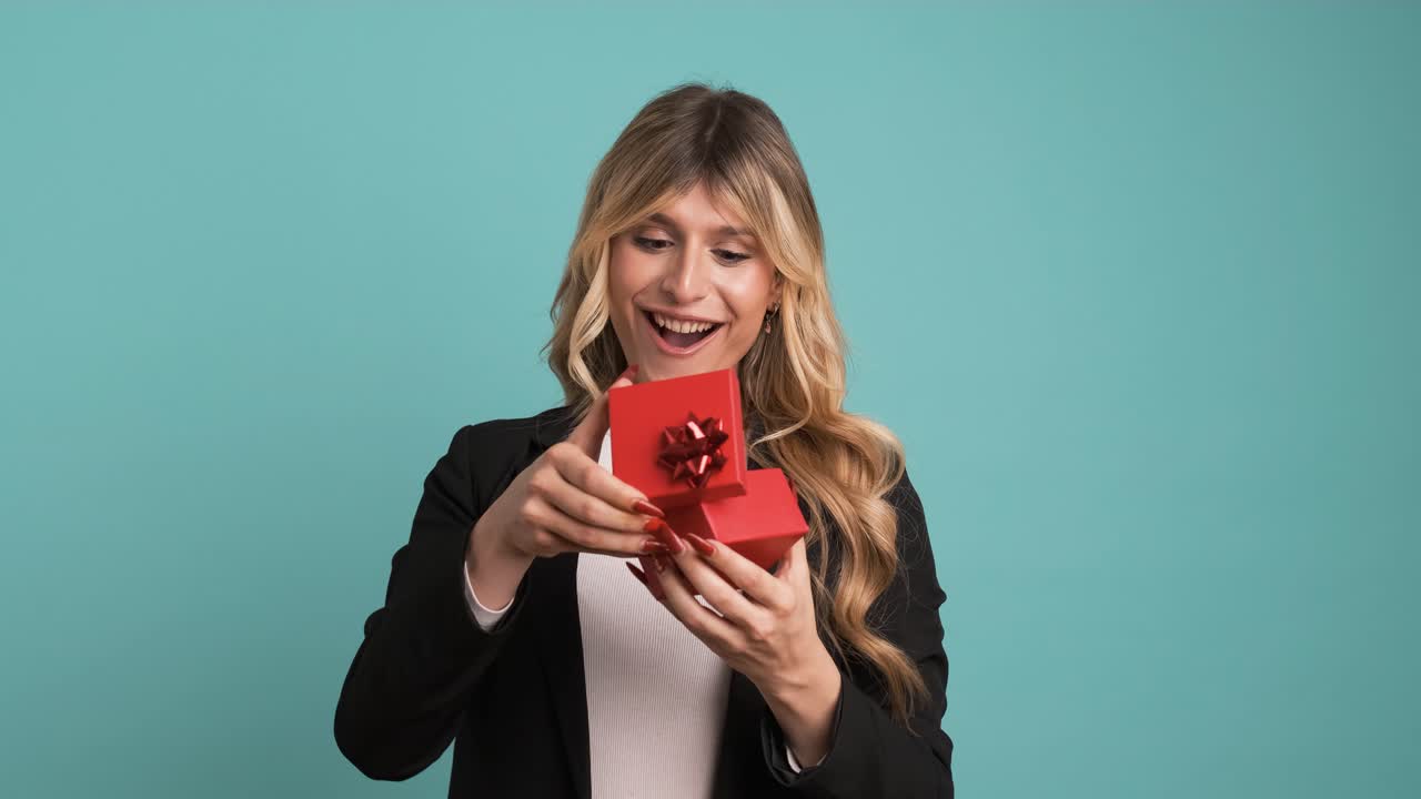 Excited transgender businesswoman opening small gift box